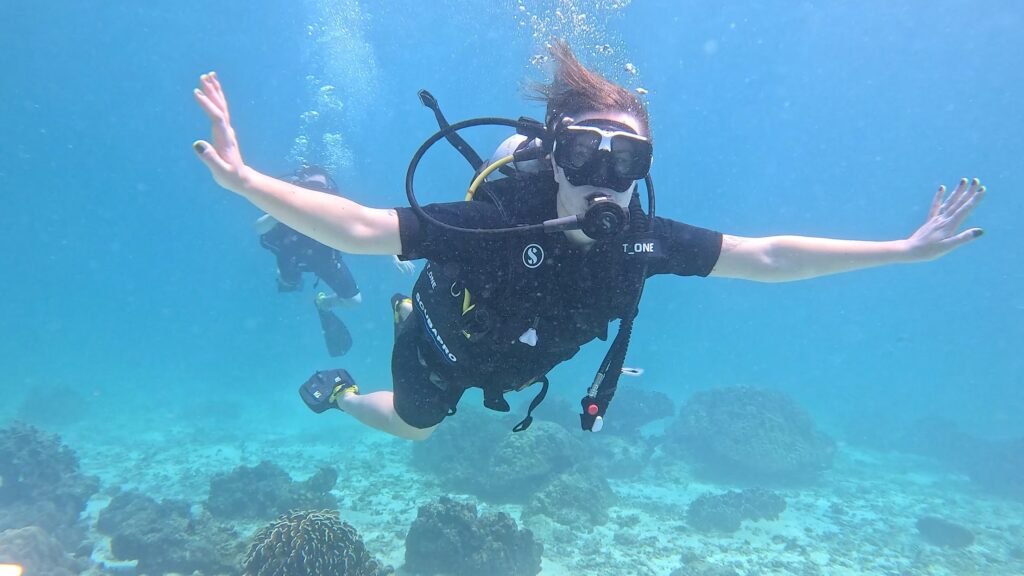 A scuba diver above a coral reef
